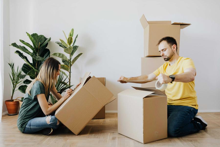 Couple packing to move home