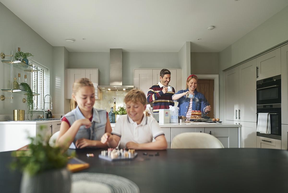 Family with children enjoying their new Bellway home
