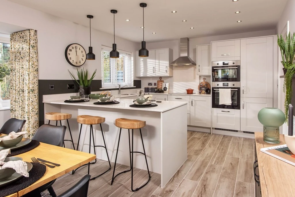 Modern open plan kitchen with breakfast bar leading onto a dining room